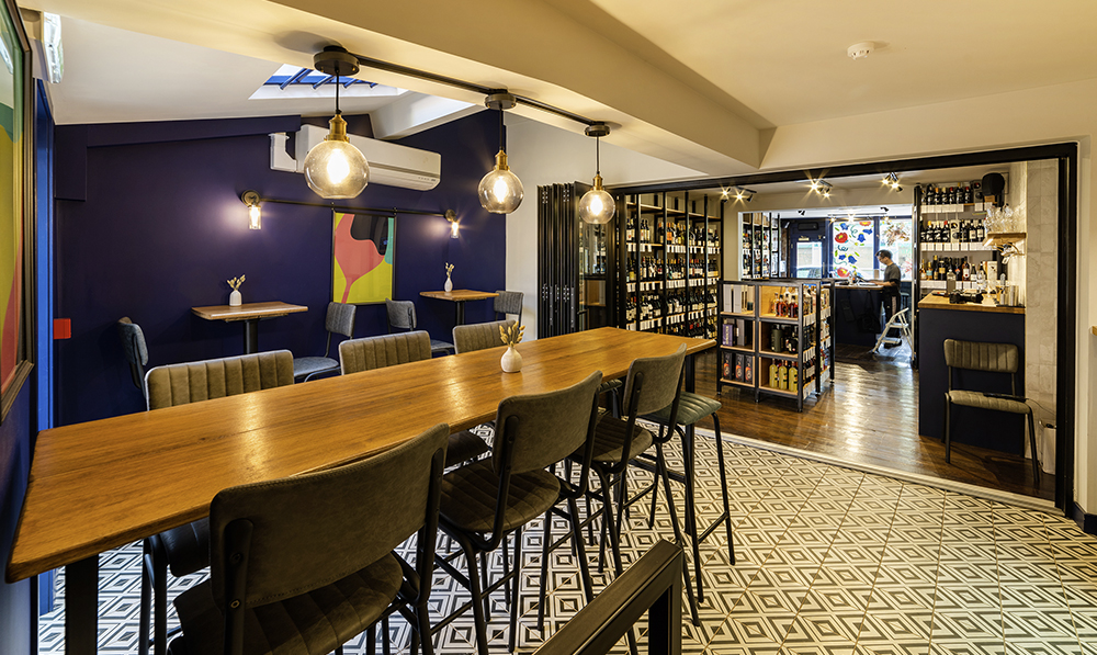 An illuminated bar setting with Brooklyn patterned floor tiles